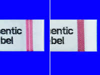 At left:The AMFS label as seen by the naked eye. Note the white line. At right:The AMFS label as seen through the viewer. Note that the white line shows up as a different color.